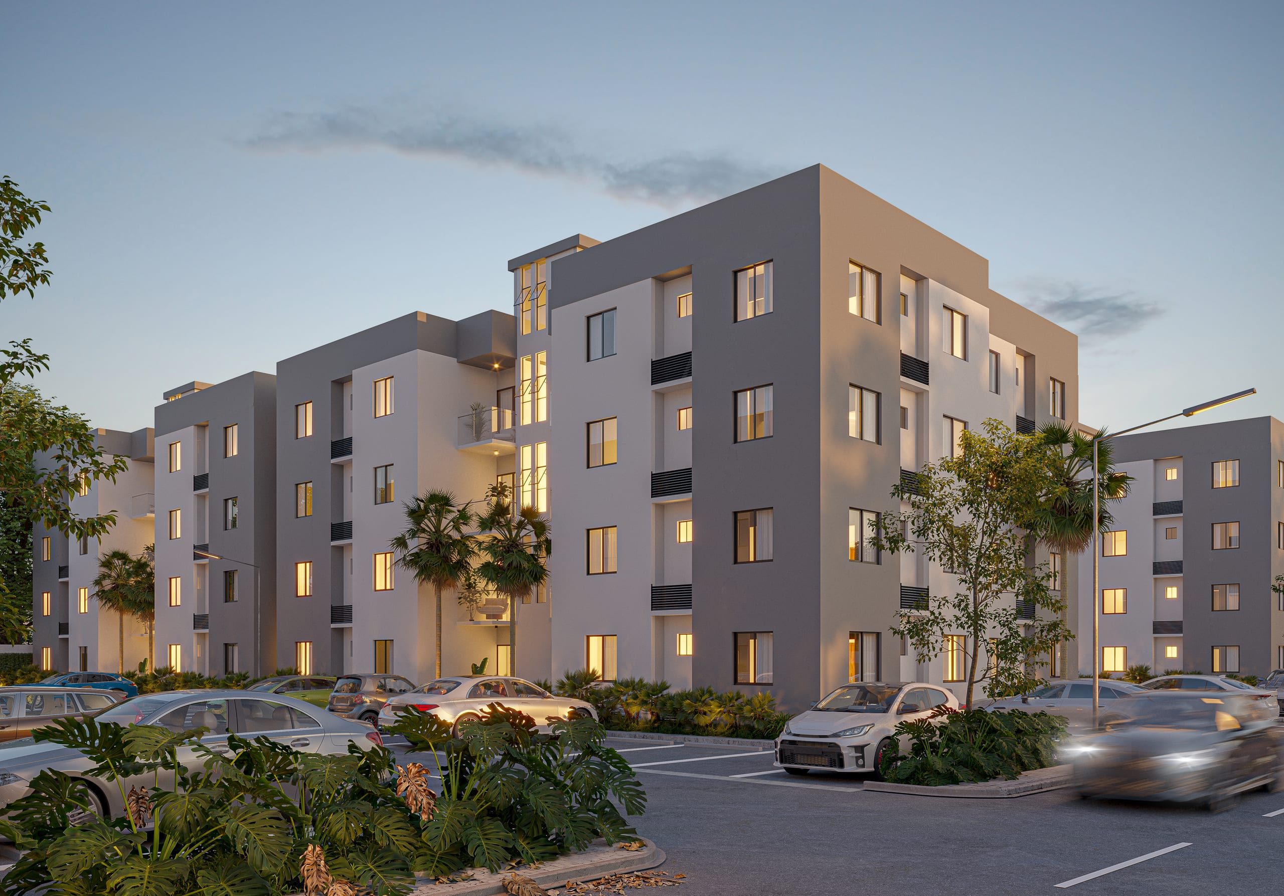 Edificios de apartamentos al atardecer con parqueos al frente